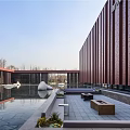 Modern Sales Office Building With Red Brown Perforated Metal Facade And Water Reflection