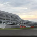 Modern School Building Exterior With Glass Walls Curved Design Red Accents Lawn And Parking Lot