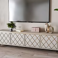 Elegant TV Stand With Diamond Pattern Gold Legs Green Plant And Decorative Items