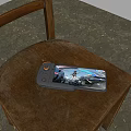 Handheld Gaming Device With Control Buttons Displaying Action Game On Wooden Chair