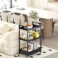 Cozy Living And Dining Room With Beige Sofa Black Shelf Fruits Snacks Books White Table