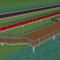 Scenic Boardwalk Path With Lush Trees Green Grass And People Walking Along Waterfront