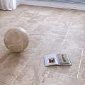 Beige Square Textured Floor Tiles In Bright Indoor Space With Decorative Sphere And Open Book
