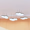 Cloud shaped white pendant lights hanging from ceiling with light colored wall and natural light