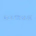 Green Neon Decorative Light With BOUTIQUE Text On Dark Blue Background