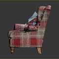 Plaid Upholstered Armchair With Red And Blue Pillows And Wooden Legs