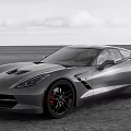 Gray Sports Car With Sleek Design Black Wheels And Red Brake Calipers On Open Road