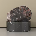Natural Red Brown Stone Displayed On Black Marble Base With White Veins
