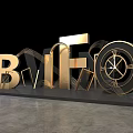 Golden Illuminated 3D Letters RIFIO with Geometric Lines on Black Background and Gray Floor