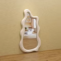 Light Colored Irregular Wavy Frame Mirror Hung On Beige Wall Reflecting Room Interior