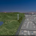 Scenic Tower On Green Hill With Lake And Distant City Lights At Night