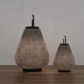 Two Woven Table Lamps in Different Sizes on Wooden Floor with White Wall