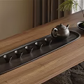 Black Ceramic Tea Set With Teapot And Small Cups On Wooden Tray And Decorative Plant