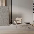 Modern Beige Leisure Chair With Metal Frame And Small Round Side Table In Minimalist Space