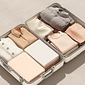 Neatly Folded Clothing Items In Open Suitcase With Soft Color Tones And Various Styles