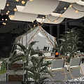 Modern Hot Pot Restaurant Interior With Green Plants Hanging Lights Seating Area And Stone Decorations
