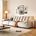 Cream Colored Leather Three Seater Sofa with Throw Blanket and Wall Art in Living Room