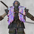 Man with colorful long hair holding long staff in feathered outfit dark pants brown boots