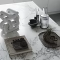 Decorative Ornament Set With White Spiral Sculpture Black Diffuser And Metal Tray On Marble Countertop