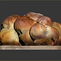 Golden Brown Braided Bread On Wooden Cutting Board With Glossy Finish