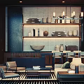 Cozy Hotel Public Lounge Area With Shelves Vases Books Fireplace And Warm Lighting