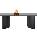 Modern Black Wooden Dining Table With Cylindrical Legs Topped With Brown Bottle And Small Cup