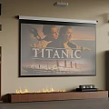 Projection Monitoring For Home Theater Setup With Titanic Movie On Projection Screen And Speakers