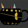 Black Mug With Gold Flower Decorations And Colorful Crayons Inside