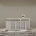 White Kitchen Island Cabinet With Glass Doors And Vase Of Pink Flowers On Wooden Floor