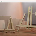 Wooden Art Easels And Canvases In Various Sizes On Wooden Floor With Light Walls