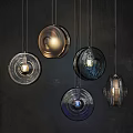 Multiple Modern Design Pendant Lights With Glass And Metal Suspended On Dark Background