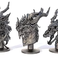 Three Intricate Metal Dragon Head Sculptures With Detailed Horns And Fierce Expressions