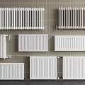 Various Styles Of White Radiators Mounted On Tiled Wall For Home Heating Solutions
