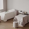 Spa Room With Two Massage Beds White Sheets Stools And Trays Of Bottles