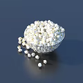 Fresh Popcorn in Glass Bowl with Scattered Pieces on Dark Surface