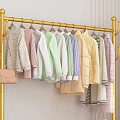 Golden Clothes Rack With Multiple Hanging Clothes Storage Shelf Near Sofa And Sunflower Decor