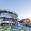 Modern Cultural Center Building With Circular Glass Facade And Surrounding Trees
