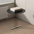 Modern Round Side Table With Black Top And Transparent Glass Stand Holding Two Books