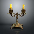 Brass Double Candle Holder With Two Yellow Candles And Decorative Carvings On Ornate Base