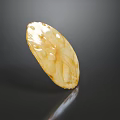 Yellow Oval Shaped Food With Carved Patterns On Dark Background Shiny Surface