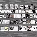 Different Books And Magazines Neatly Arranged On Grey Floor With Diverse Covers