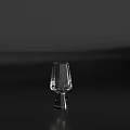 Transparent Glass Wine Glass With Slender Body And Wide Base On Black Tabletop