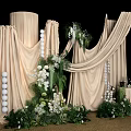 Elegant Floral Installation Featuring Beige Drapes White Flowers And Lush Greenery