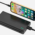 Smartphone Being Charged By Black Portable Power Bank With Screen Showing App Icons
