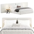 Modern Upholstered Double Bed With White Pillows Striped Blanket And Wooden Side Table
