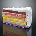 Colorful Layered Rainbow Cake Slice With Creamy Frosting And Vibrant Layers