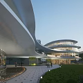 Contemporary Hotel Building With Curved Design Glass Facade Green Lawn And Walkway