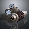 Three Industrial Cylindrical Components with Ribbed Metal Surface Red Top Indicators and Stacked Design