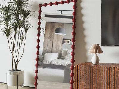 Red Beaded Frame Mirror Reflecting Bedroom Scene Green Plant Wooden Cabinet and White Table Lamp 3d model
