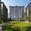 High Rise Residential Building Complex With Lush Green Lawn And Trees